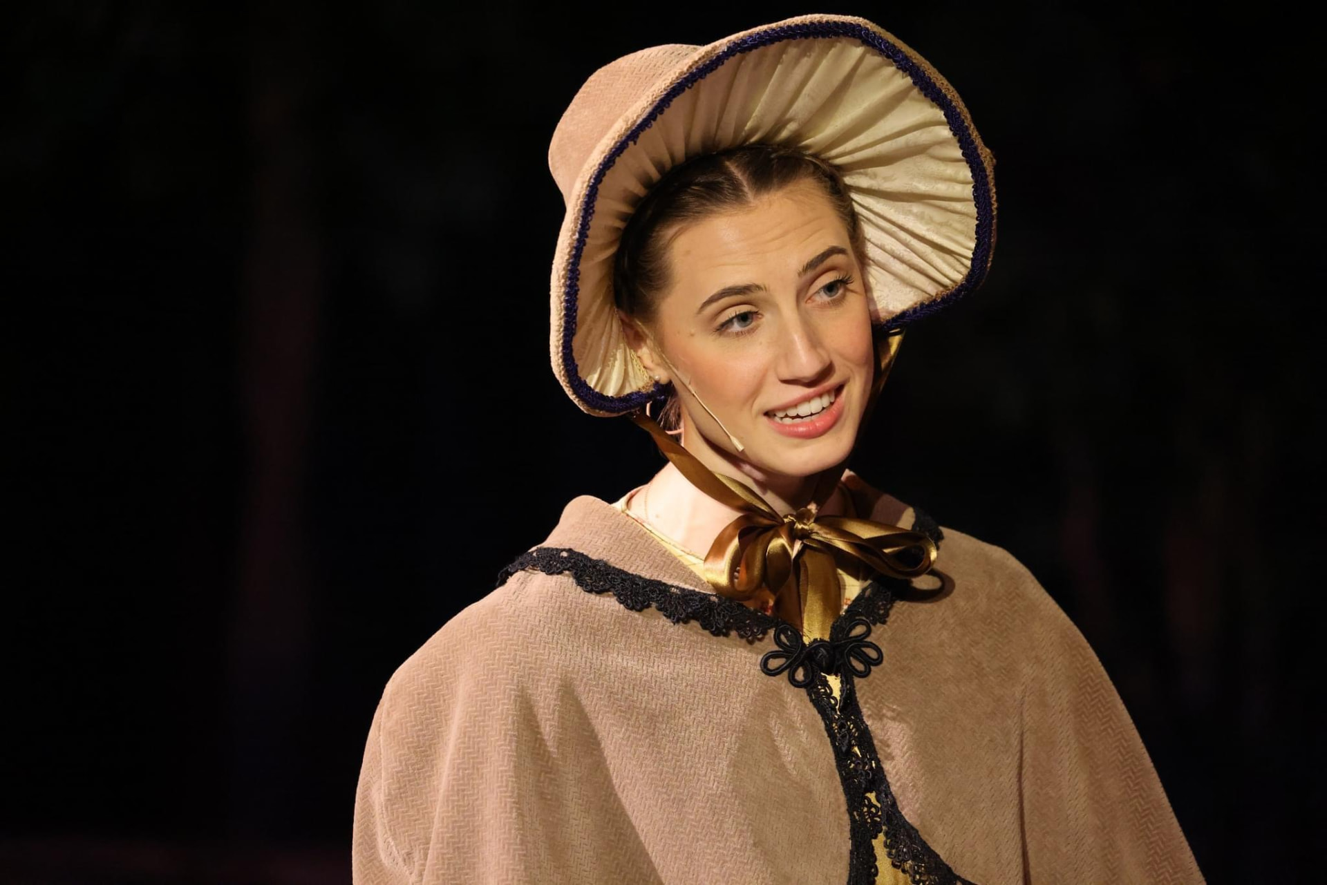 Autumn in 1800s bonnet and cape as a historic performer